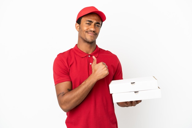 African American pizza delivery man picking up pizza boxes over isolated white wall proud and self-satisfied