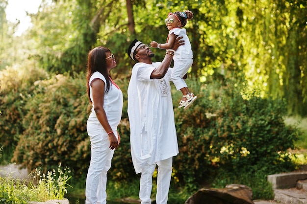 Photo african american rich family having fun on sunset father throws daughter on his hands