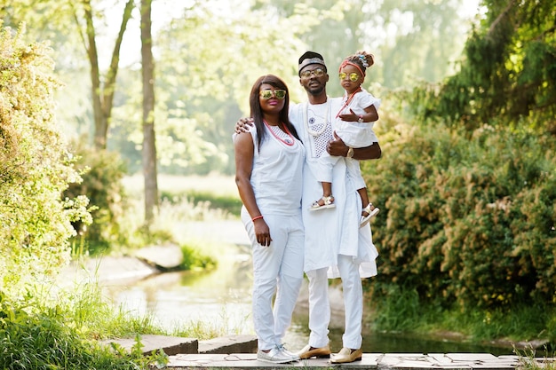 African american rich family at white nigerian national clothing