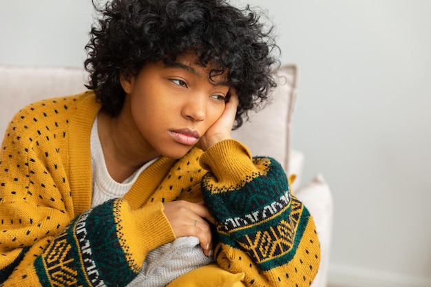 African american sad thoughtful girl at home young african woman feels depressed offended lonely ups