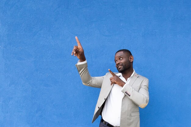 The African American shows hands up on blue background