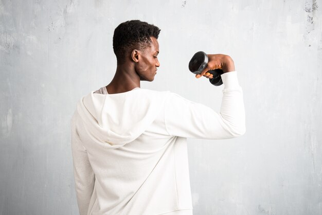 African american  sportman making weightlifting