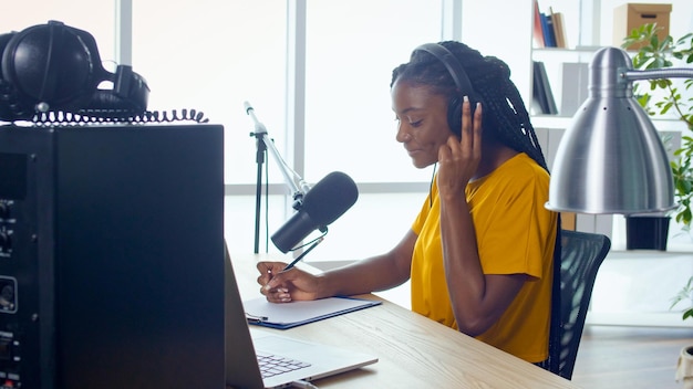 african american streamer leads a podcast and answers questions in the studio