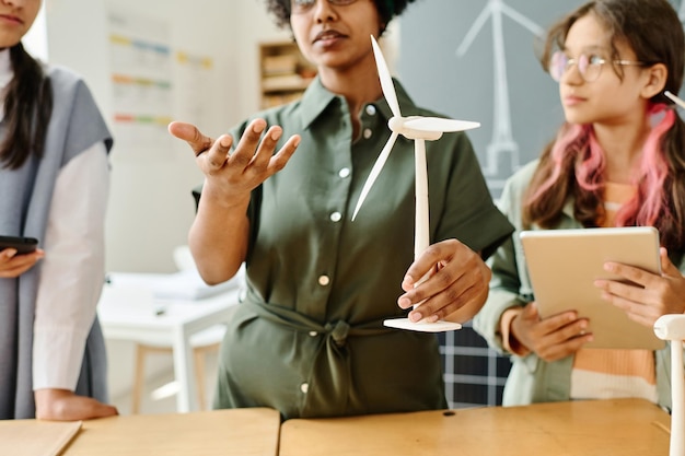 African american teacher talking about windmill to students at lesson