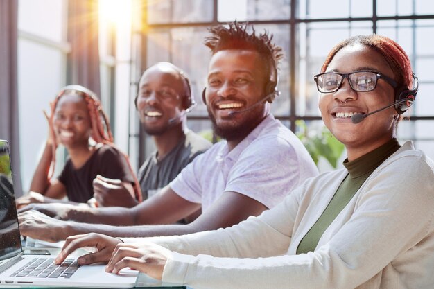 African american team working at call center office to help people with telemarketing assistance