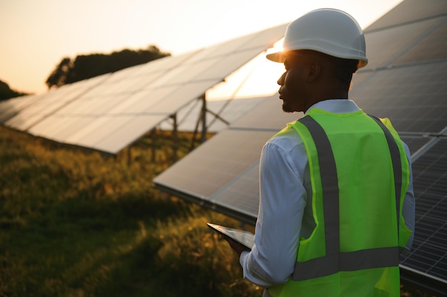 African american technician check the maintenance of the solar panels Black man engineer at solar station