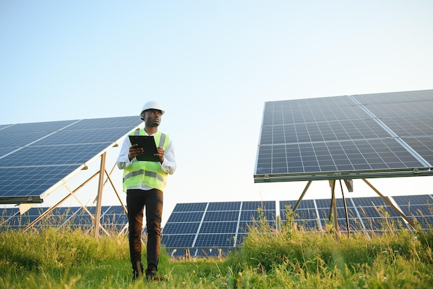 African american technician check the maintenance of the solar panels Black man engineer at solar station