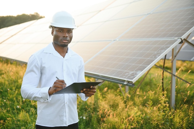 African american technician check the maintenance of the solar panels Black man engineer at solar station