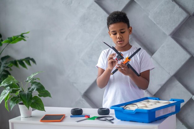 African american teen with a toy helicopter in hands