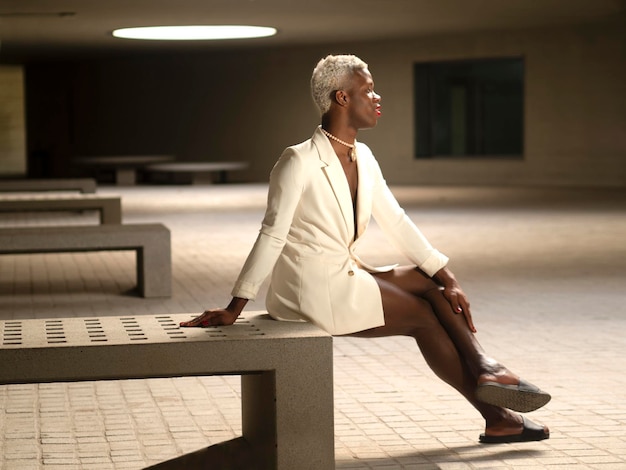 African American transgender man sitting on bench