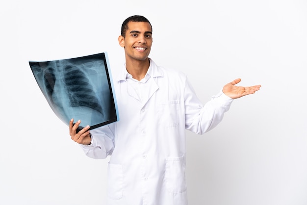 African american traumatologist on isolated whitebackground extending hands to the side for inviting to come