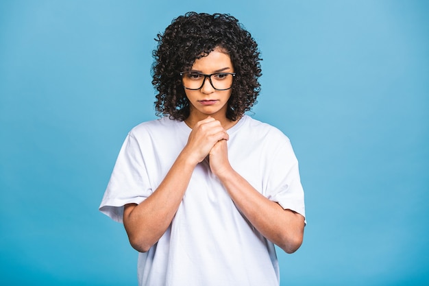 African american unhappy stressed woman thinking in frustration despair isolated blue background with copy space.