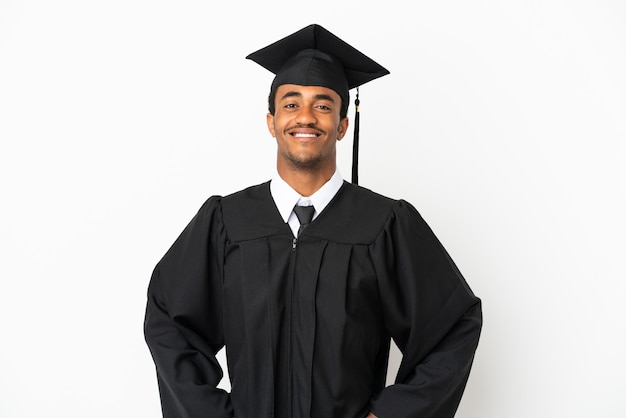 African American university graduate man over isolated white background posing with arms at hip and smiling