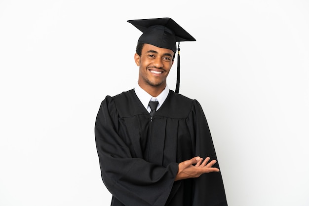 African American university graduate man over isolated white background presenting an idea while looking smiling towards