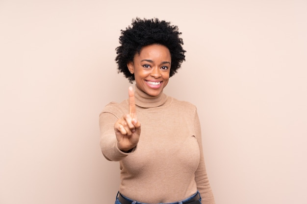 African American woman over beige wall