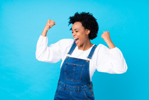 African American woman over blue wall