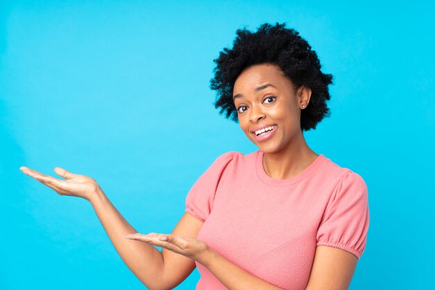 African American woman over blue wall