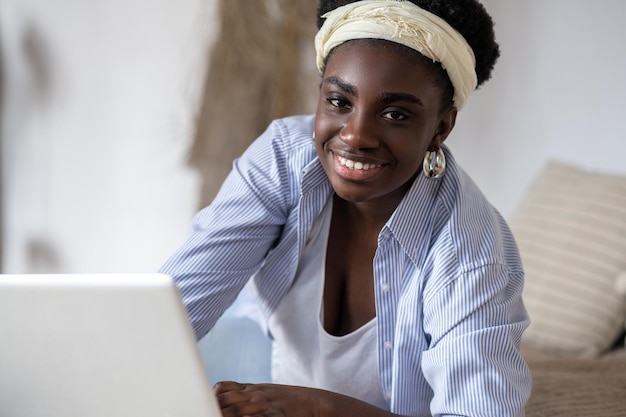 African american woman chatting on internet and looking involved