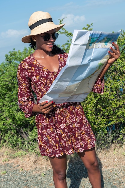 African American woman exploring the map while in the mountains