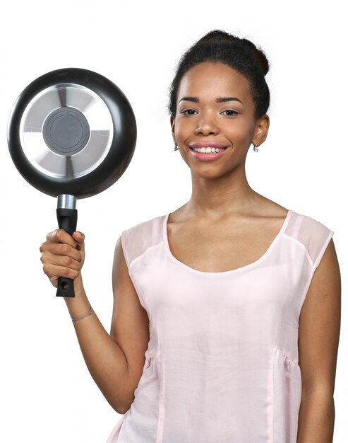 African american woman holding kitchen utensils