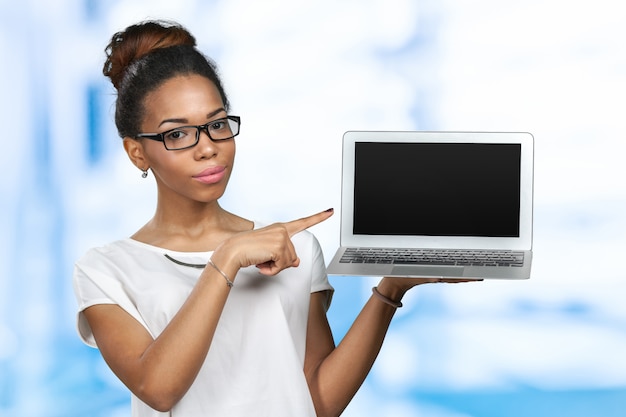 African american woman holding laptop