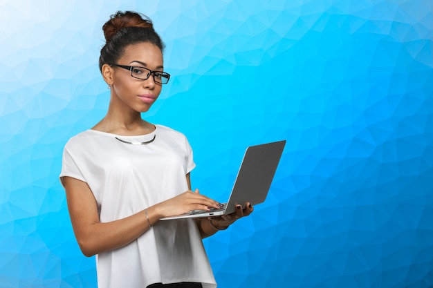 African american woman holding laptop