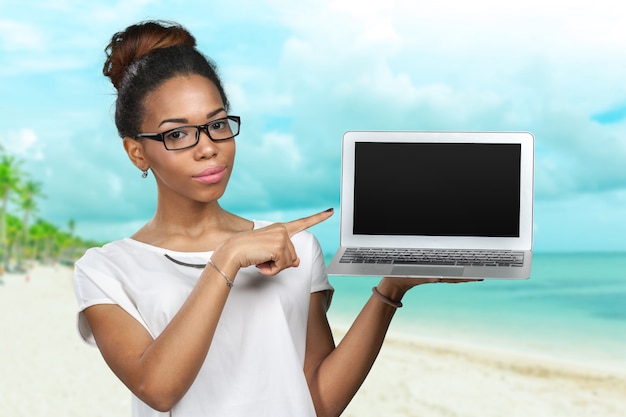 African american woman holding laptop