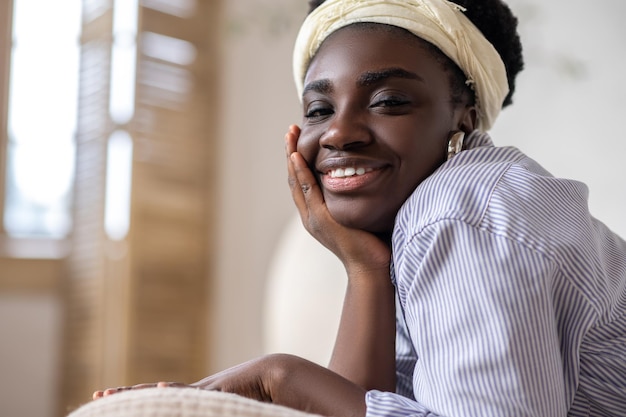 African american woman laying on bed and looking dreamy