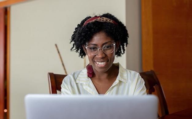 African American woman looking at laptop screen