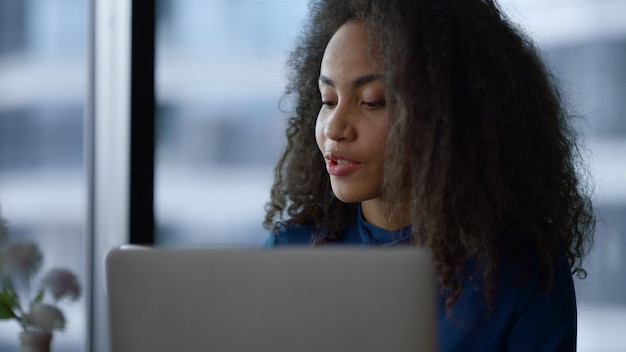 african american woman manager enjoy working computer laptop drinking morning coffee in home office portrait of young executive browsing web discussing work in company corporate technology concept