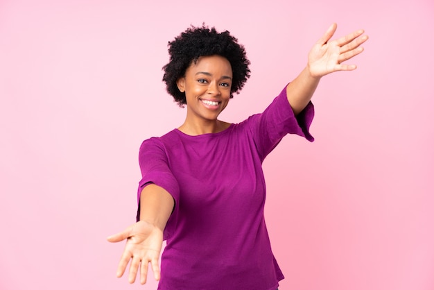 African American woman over pink wall