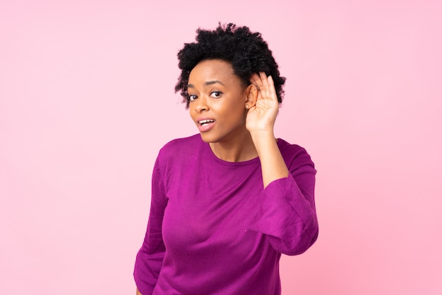 African American woman over pink wall