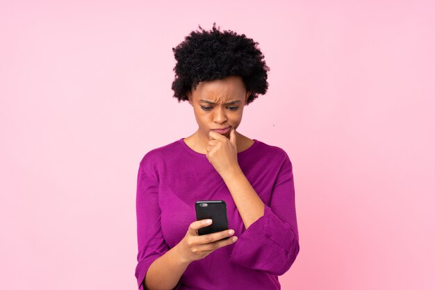 African American woman over pink wall