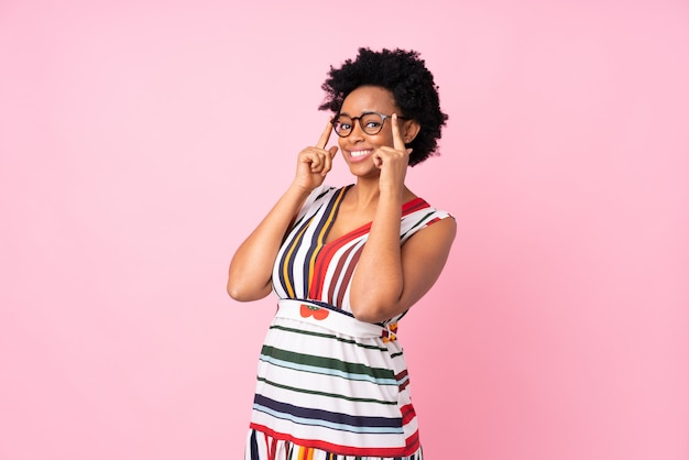 African American woman over pink wall