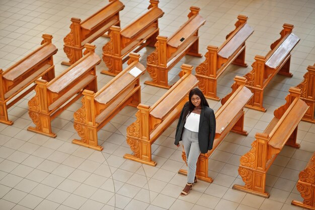 African american woman praying in the church Believers meditates in the cathedral and spiritual time of prayer View from above