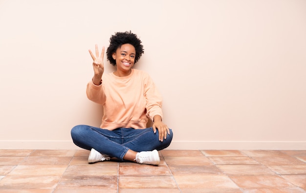 African American woman sitting on the floor