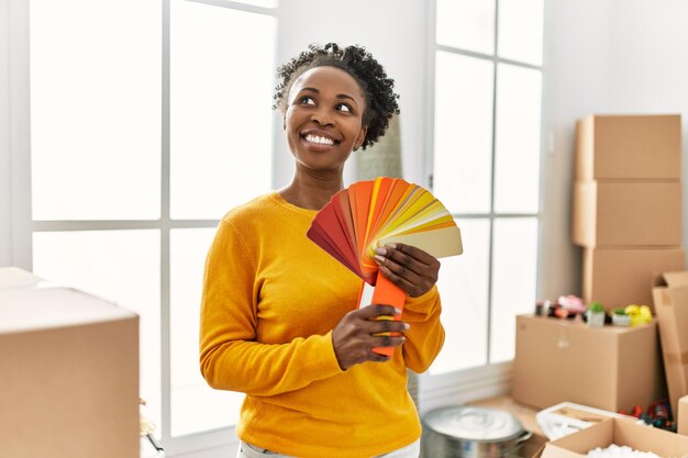 African american woman smiling confident holding color test at new home