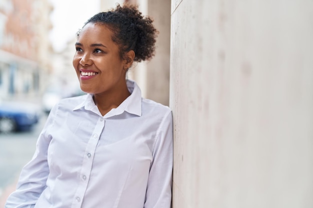 African american woman smiling confident looking to the side at street