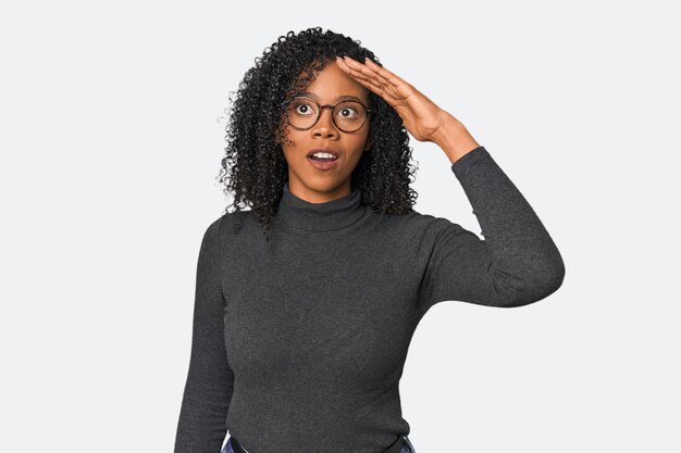 African American woman in studio setting shouts loud keeps eyes opened and hands tense