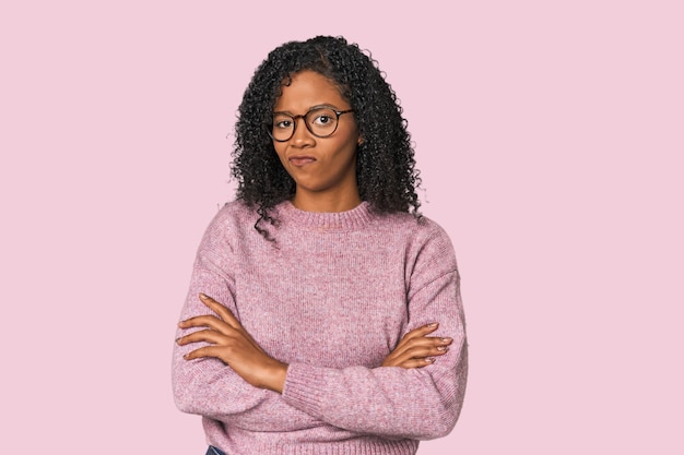 African American woman in studio setting unhappy looking in camera with sarcastic expression