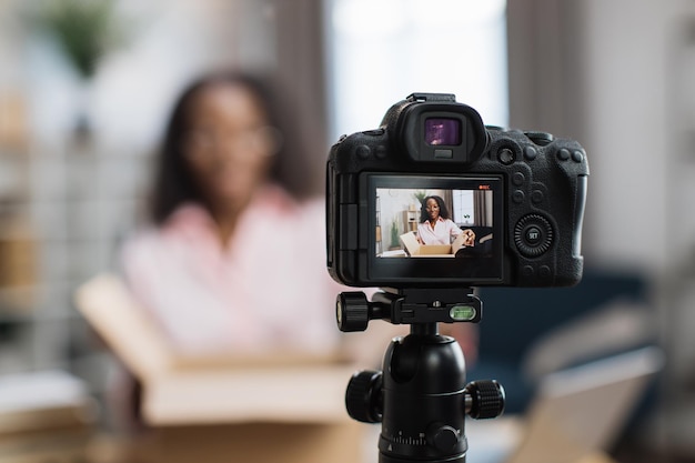 African american woman unboxing parcel and recording video