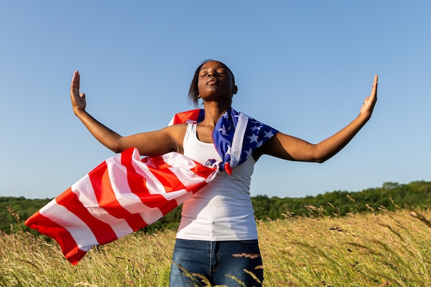 アメリカの国旗に包まれたアフリカ系アメリカ人の女性