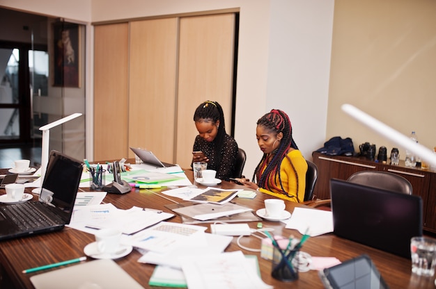 African american women colleagues, crew of divercity female partners in office sit at the table.