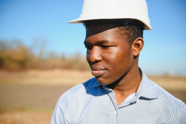 African American worker in a construction helmet