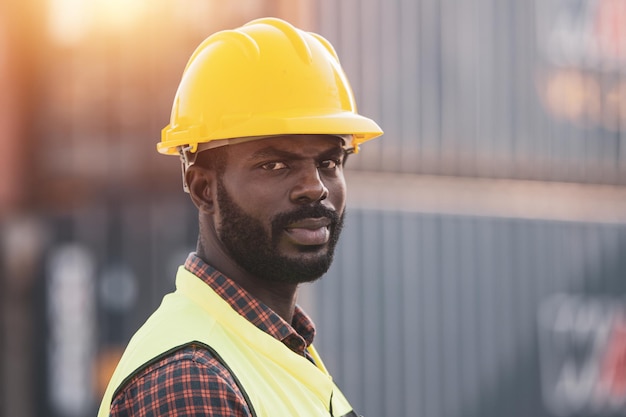 African American worker working in Importexport cargo yard largescale transportation via barges