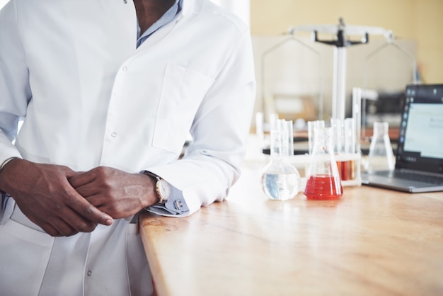 An African American worker works in a laboratory conducting experiments.