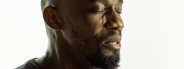 African-american young man's close up shot on studio background, flyer