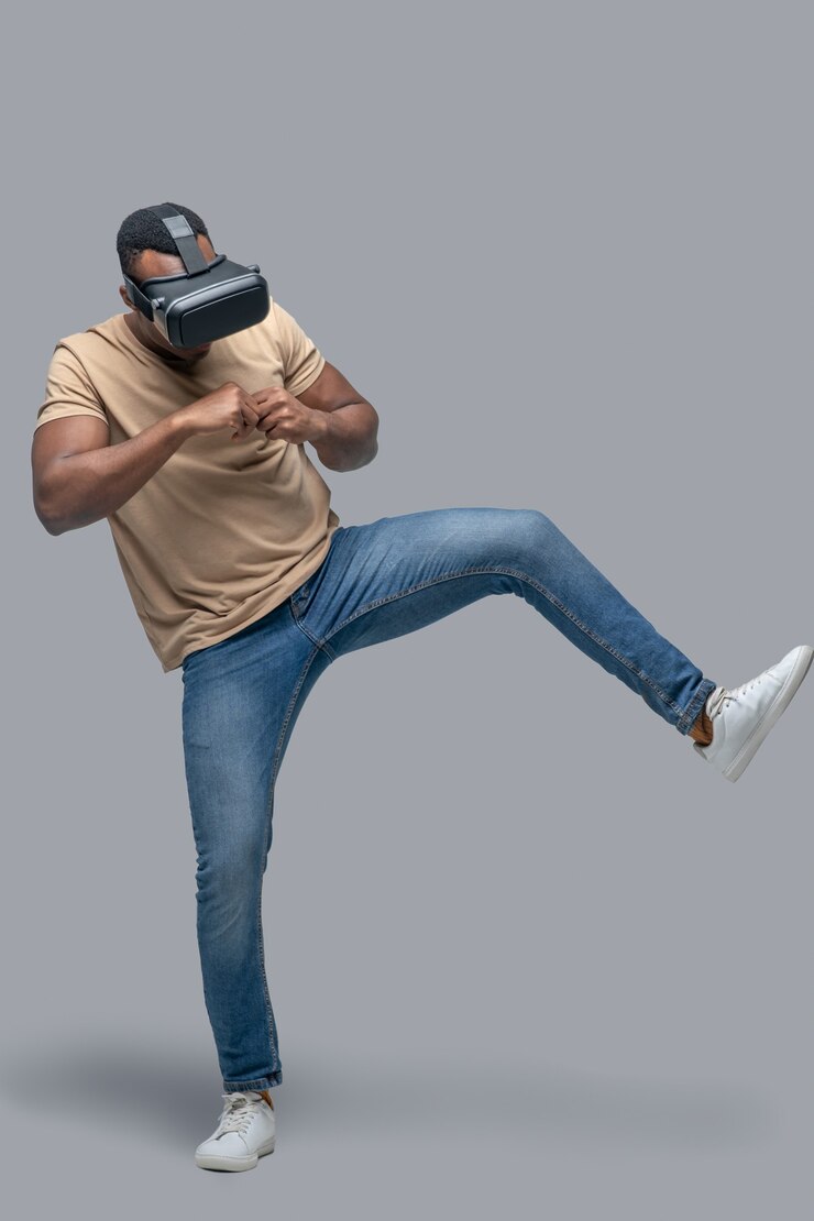 फोटो african american young man in vr glasses looking involved
