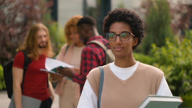 Photo african american young student woman high school schoolgirl smiling toothy happy pupil girl outdoors