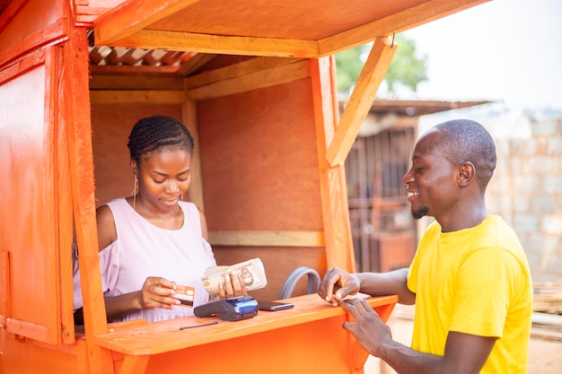 African business man collecting money for point of sale machine